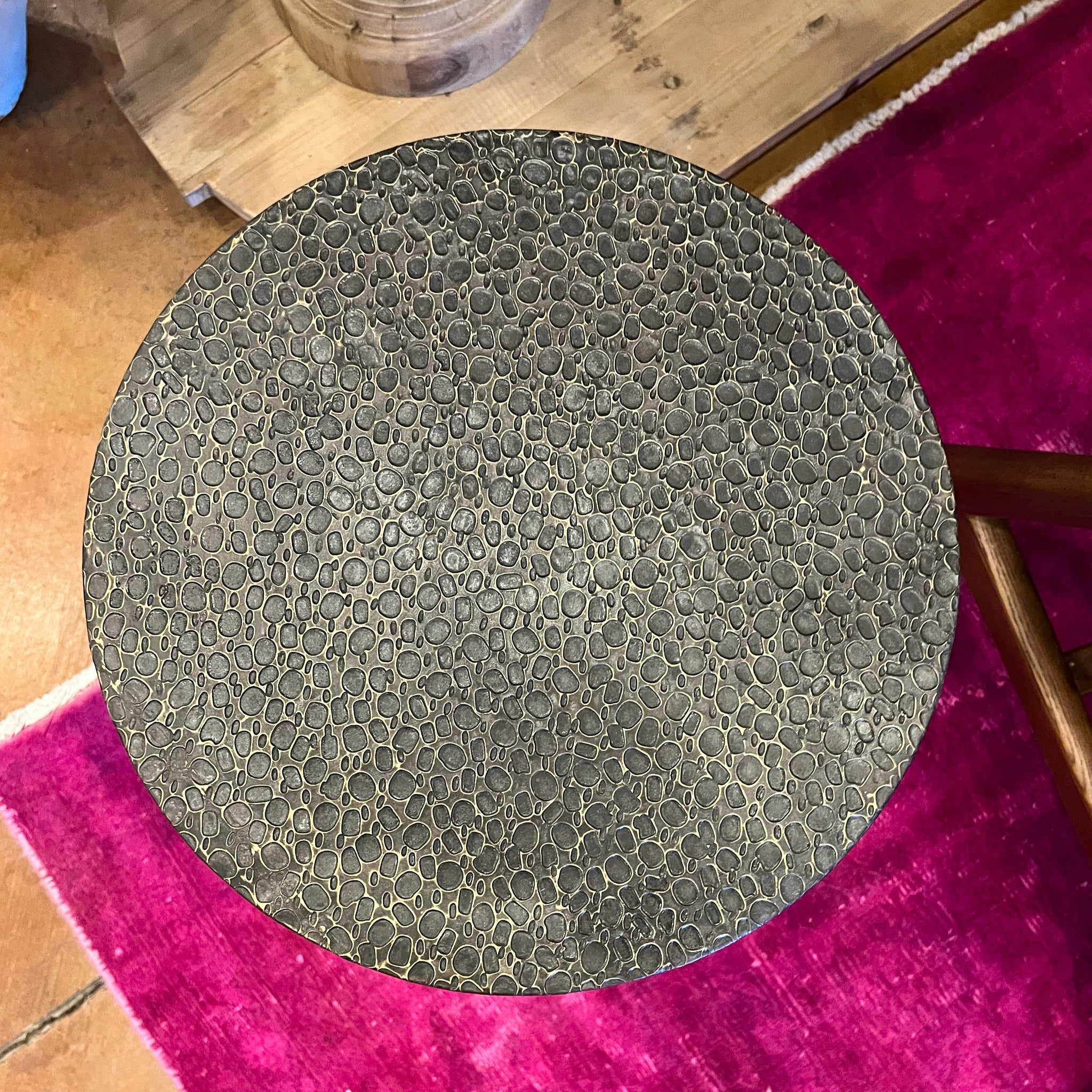 Circular textured hammered metal side table with marble base. 