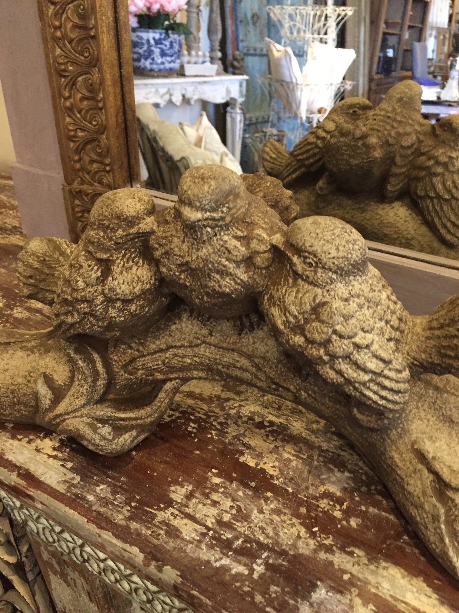 Concrete birds on branch