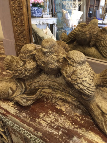 Concrete birds on branch